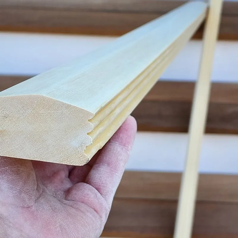 Detail image of a custom profile carved into a staircase handrail